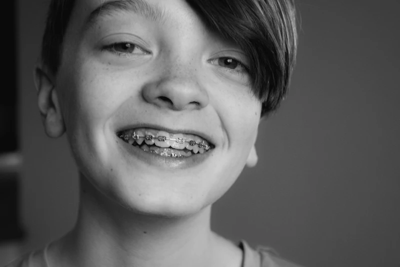 A smiling teenager wearing metal braces