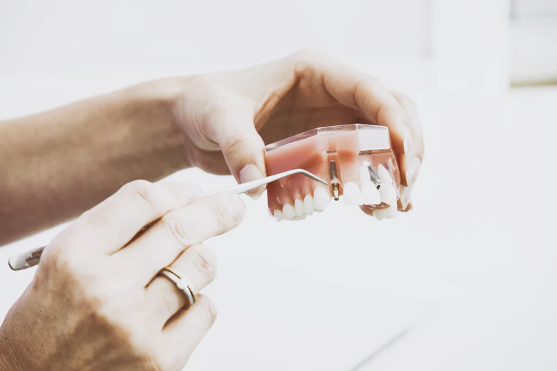 Hands holding a set of false teeth